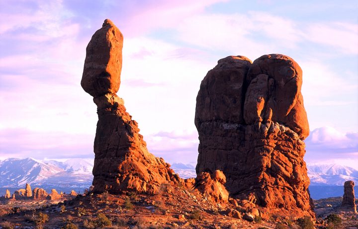 Rocky landscape with a rock formation that appears to balance a large rock.